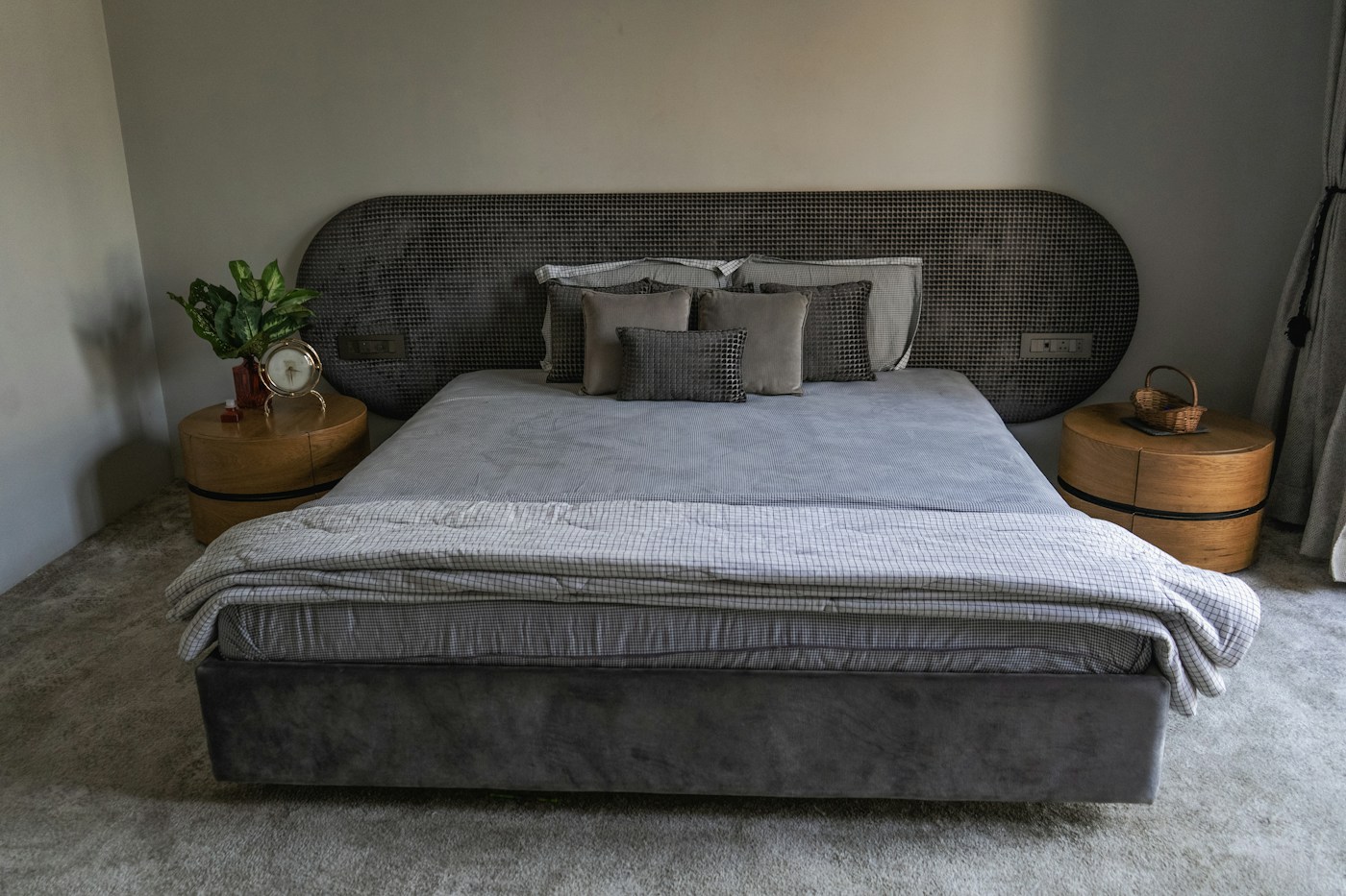 A calm bedroom with an upholstered bed and textured bedding